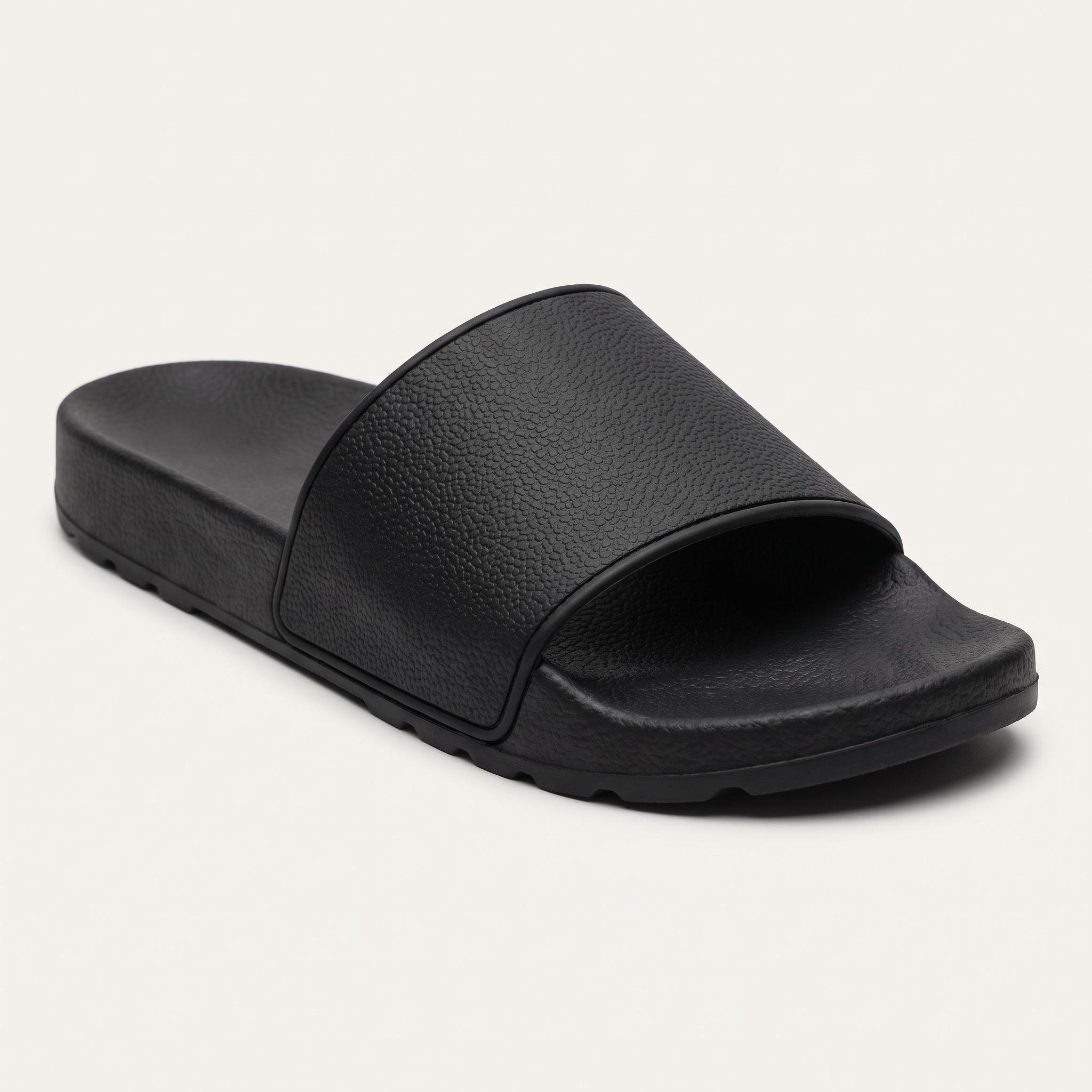 Black slide sandal, side profile